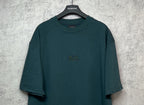 Teal short-sleeve T-shirt with crew neck and small chest emblem