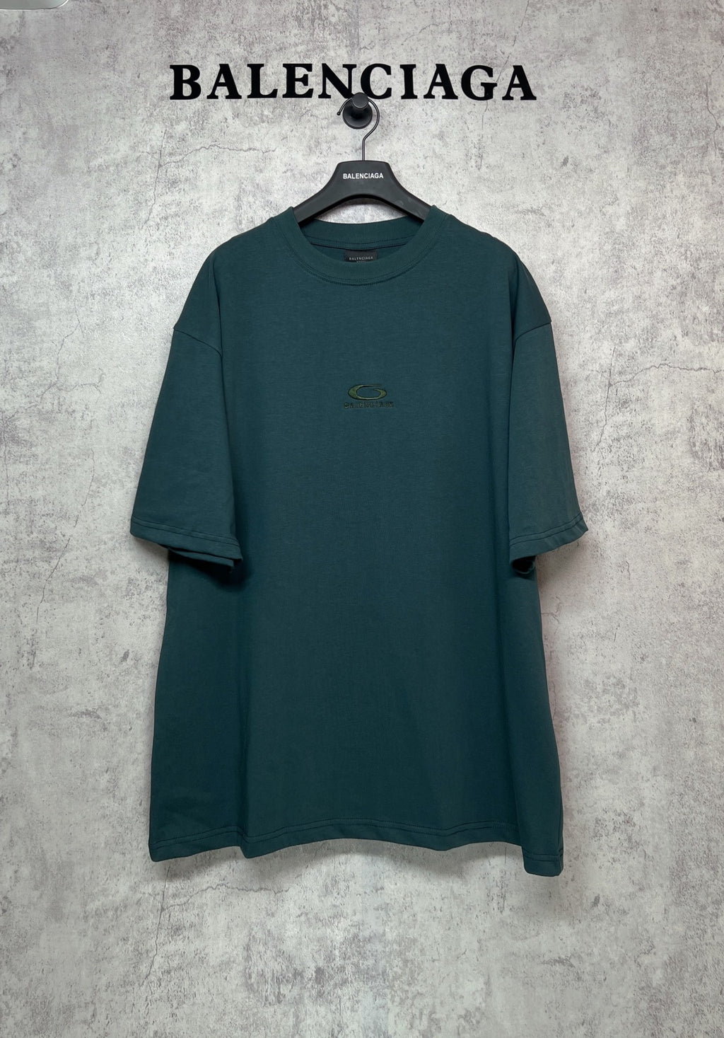 Teal short-sleeve T-shirt with crew neck and small chest emblem logo