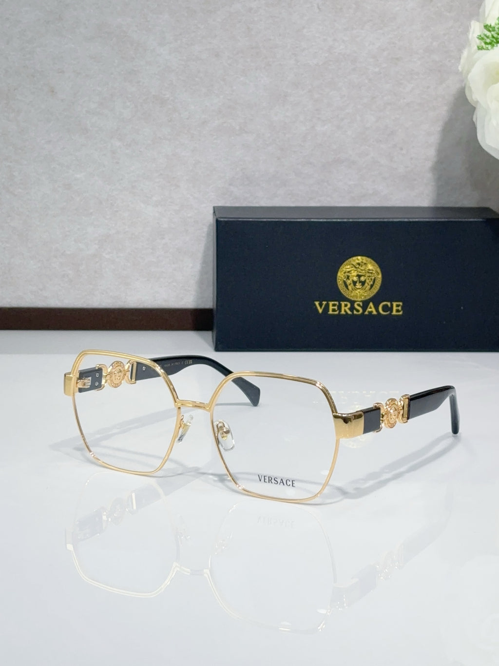 Versace eyeglasses with gold-tone full-rim frame and clear lenses, black temple tips
