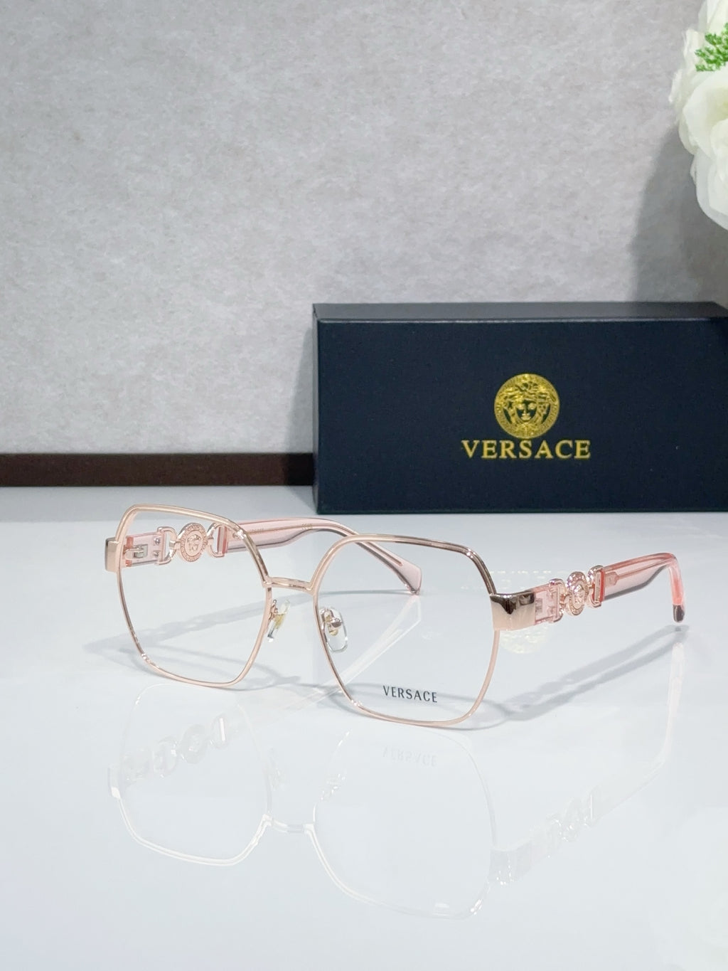 Versace eyeglasses with blush-pink full-rim frame and clear lenses, rose temples