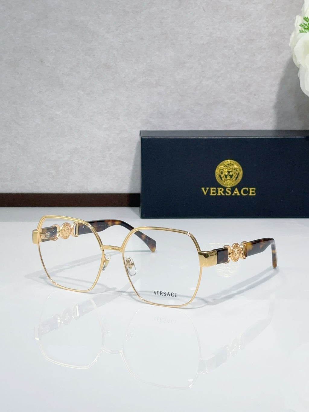 Versace eyeglasses with gold-tone full-rim frame and clear lenses, dark temple tips