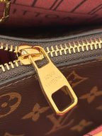 Louis Vuitton monogram zipper pull with gold slider and red striped interior