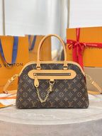 Louis Vuitton monogram handbag with tan leather handles and front strap details