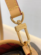 Louis Vuitton clasp hardware with gold-tone hook on red striped interior
