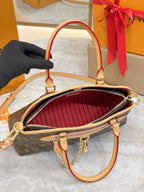 Louis Vuitton monogram bag interior with red striped lining and gold zipper trim