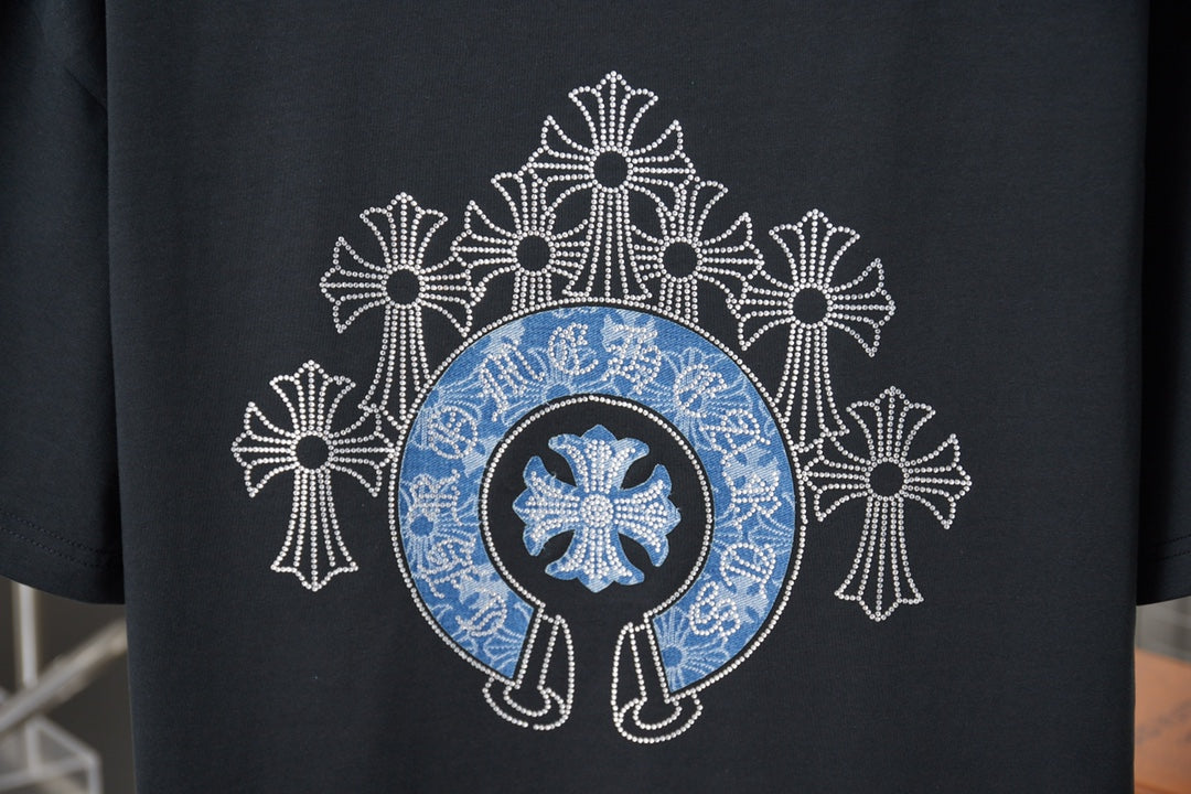 Black T-shirt back close-up showing blue emblem and white cross pattern