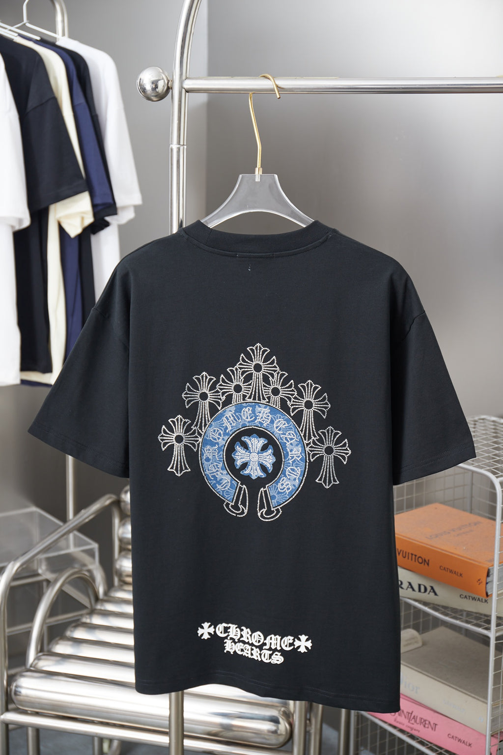 Black T-shirt with back graphic of blue emblem and white cross motifs