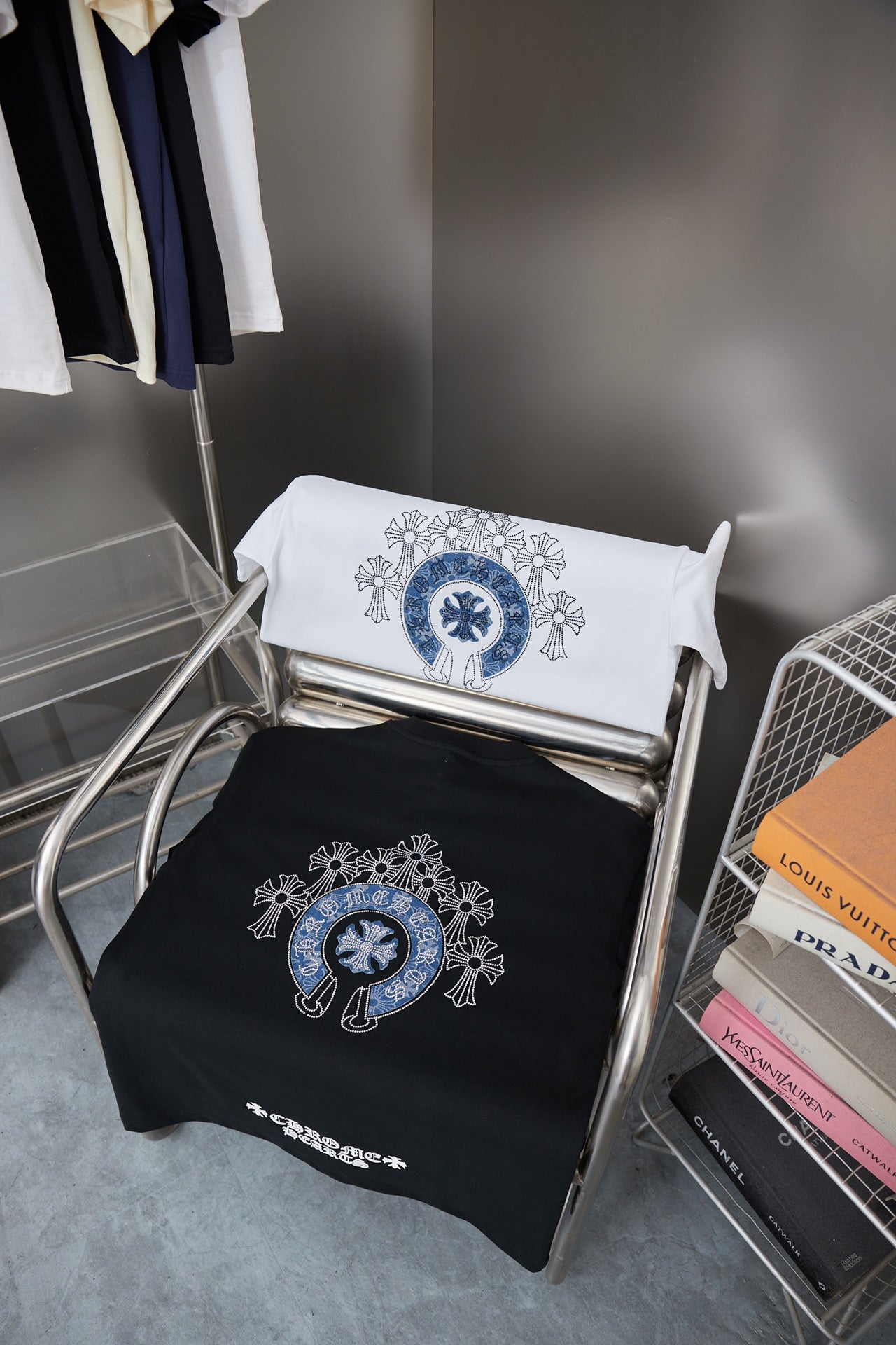 Stacked black and white T-shirts with matching blue rhinestone emblem prints