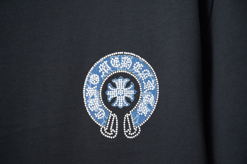 Black T-shirt front close-up of blue crystal emblem with white border
