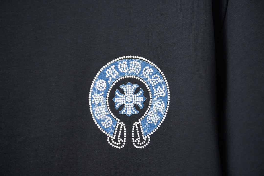 Black T-shirt front close-up of blue crystal emblem with white border
