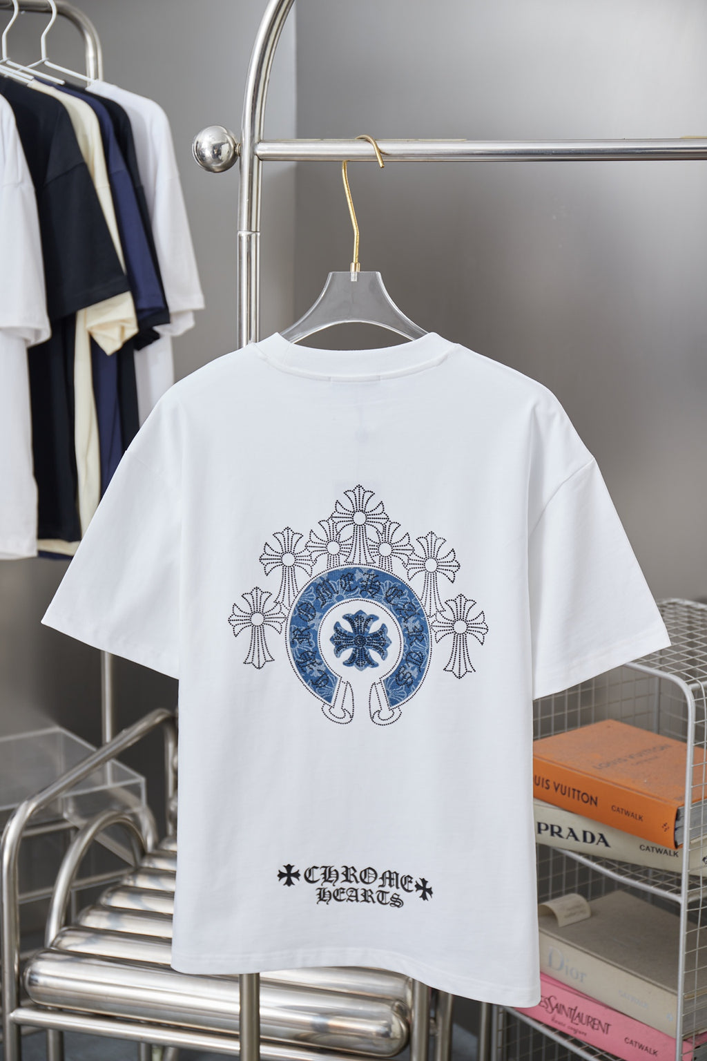 White short-sleeve T-shirt with large blue back emblem and small bottom logo