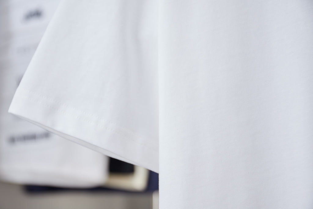White T-shirt with short sleeve and curved hem, no visible front graphic