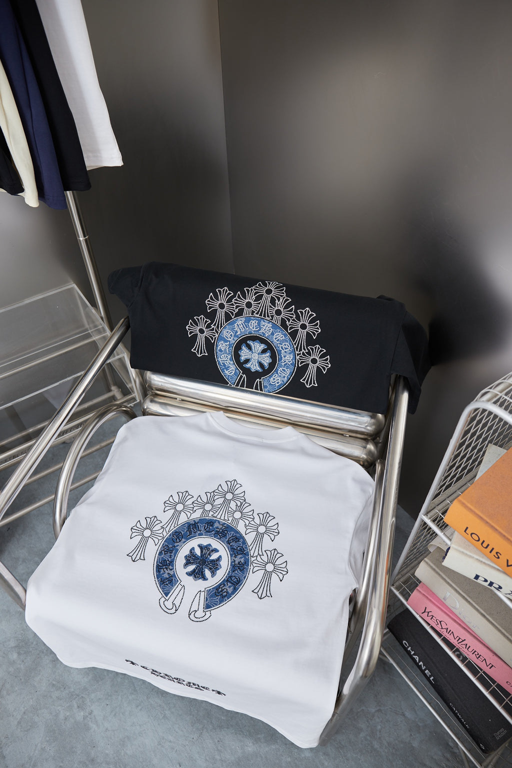 Folded black and white short-sleeve T-shirts with blue circular emblem