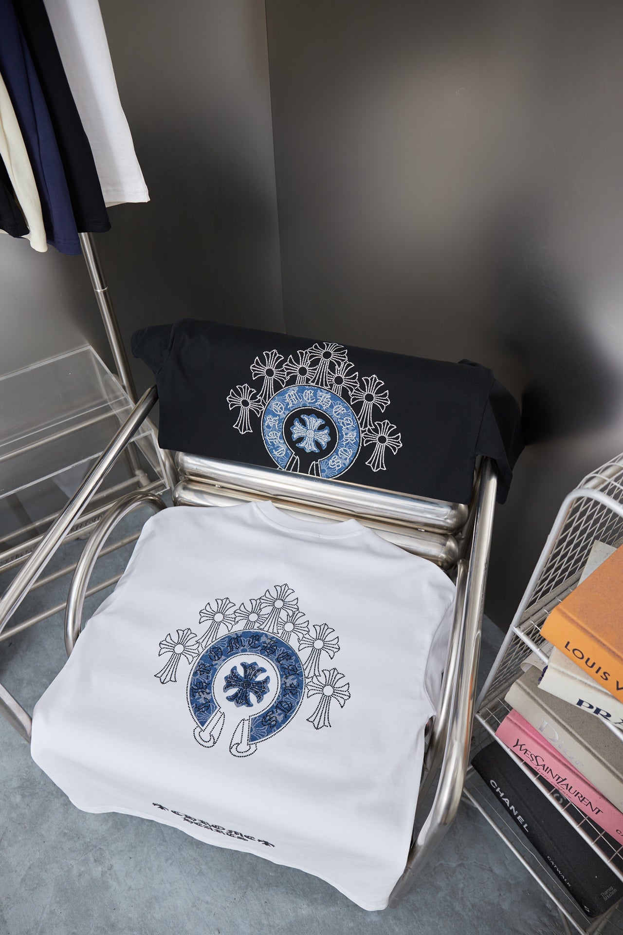 Folded black and white short-sleeve T-shirts with blue circular emblem