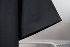 Black T-shirt sleeve and hem with visible stitching