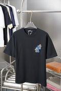 Black graphic T-shirt with blue flower cross patch on left chest