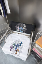 Folded black and white short-sleeve T-shirts with multicolor cross embroidery