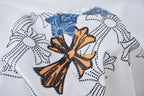 Orange, blue, and black floral cross embroidery on a white T-shirt