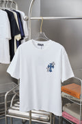 White short-sleeve T-shirt with blue cross and flower embroidery on the chest
