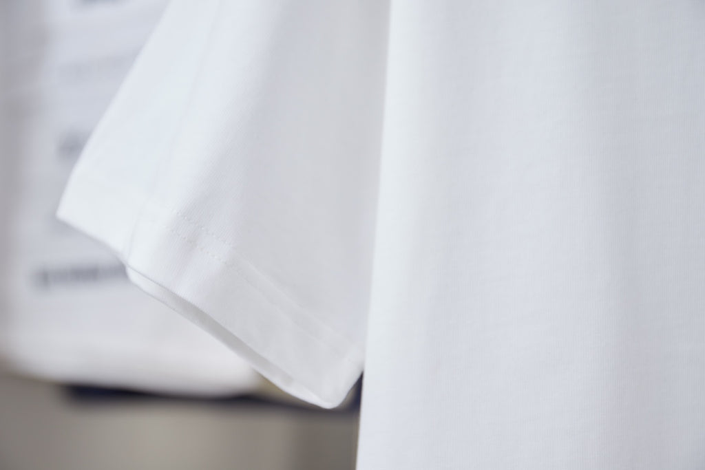 White short-sleeve T-shirt with draped fabric and clean hem