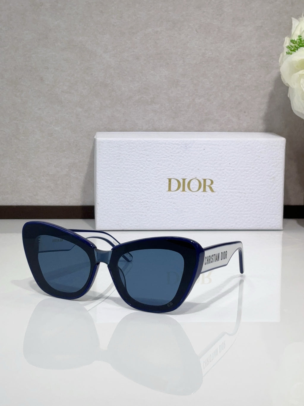 Dior sunglasses with navy frames and dark tinted lenses