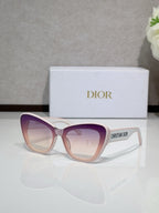 Dior sunglasses with light pink frames and purple-tinted gradient lenses