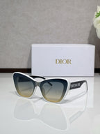 Dior sunglasses with white frames and olive-tinted lenses