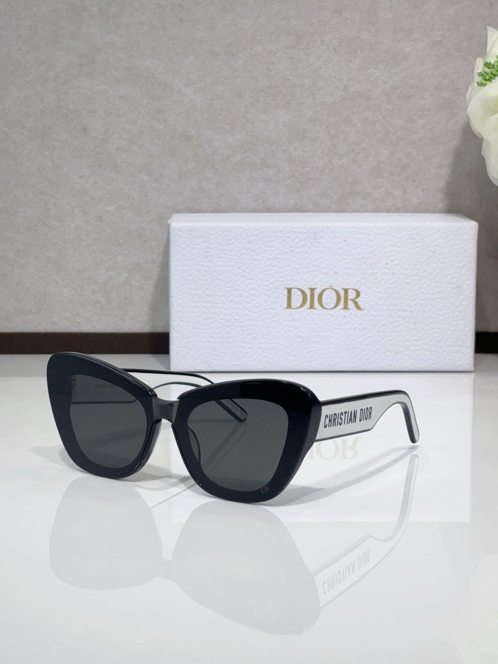 Dior sunglasses with black cat-eye frames and dark tinted lenses