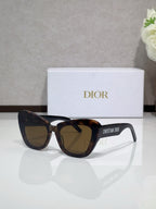 Dior sunglasses with tortoiseshell frames and warm dark tinted lenses