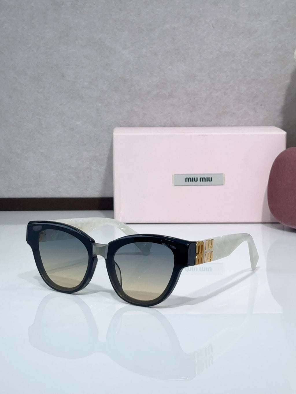 MiuMiu cat-eye sunglasses, black frames with dark tinted lenses