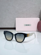 MiuMiu cat-eye sunglasses, black frames with dark tinted lenses