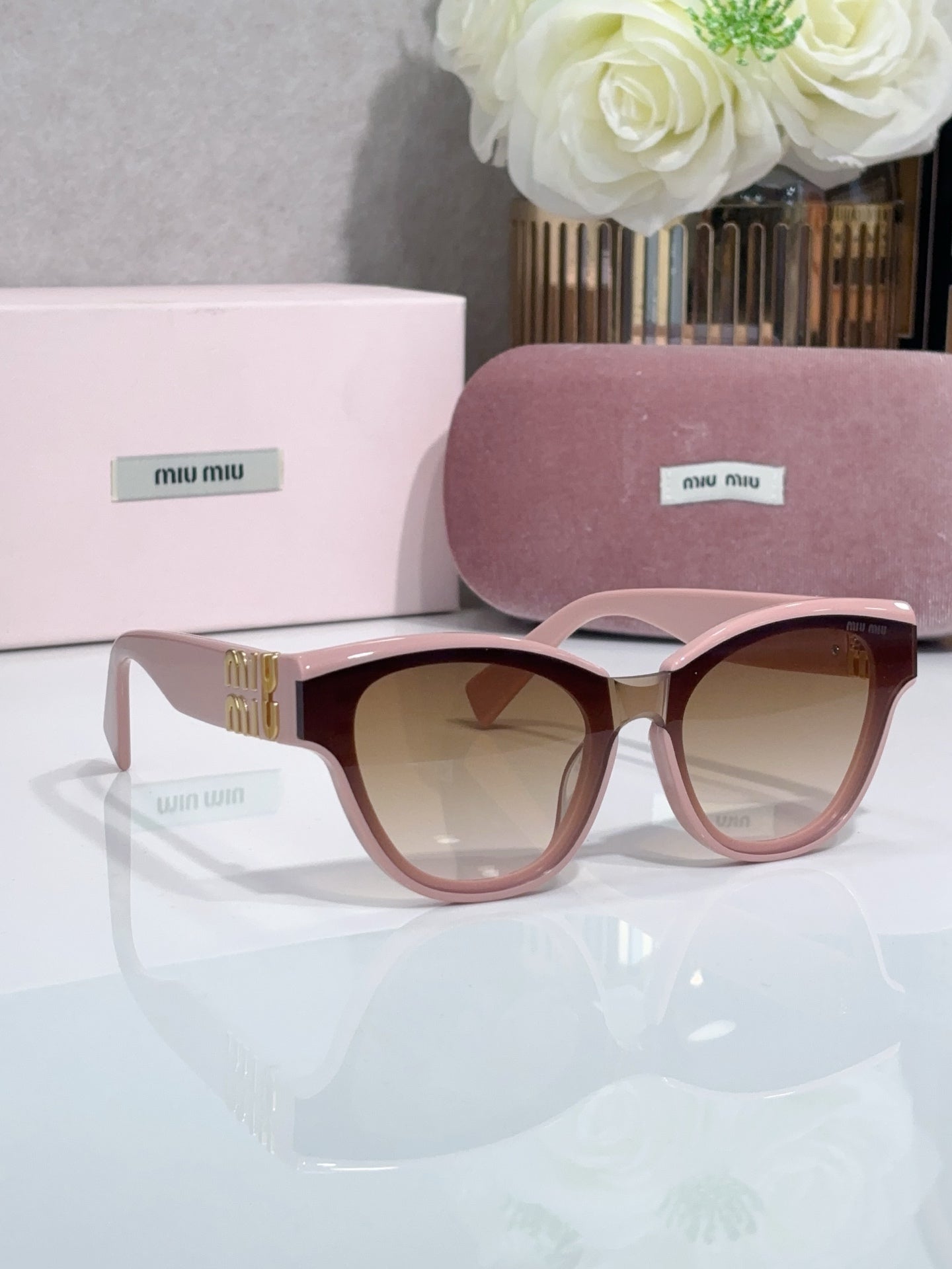 MiuMiu cat-eye sunglasses, pale pink frames with light tinted lenses