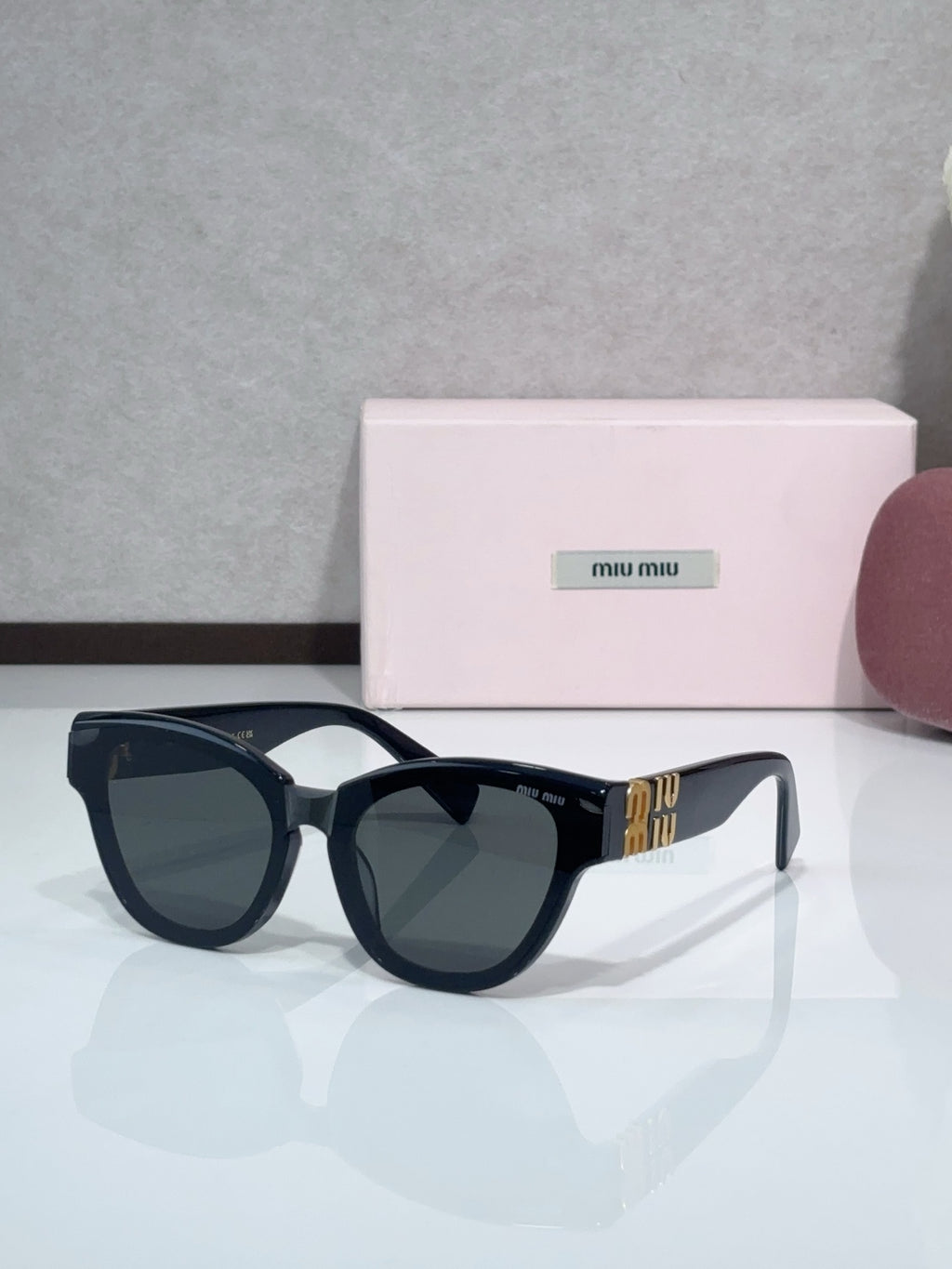 MiuMiu cat-eye sunglasses, dark navy frames with dark tinted lenses