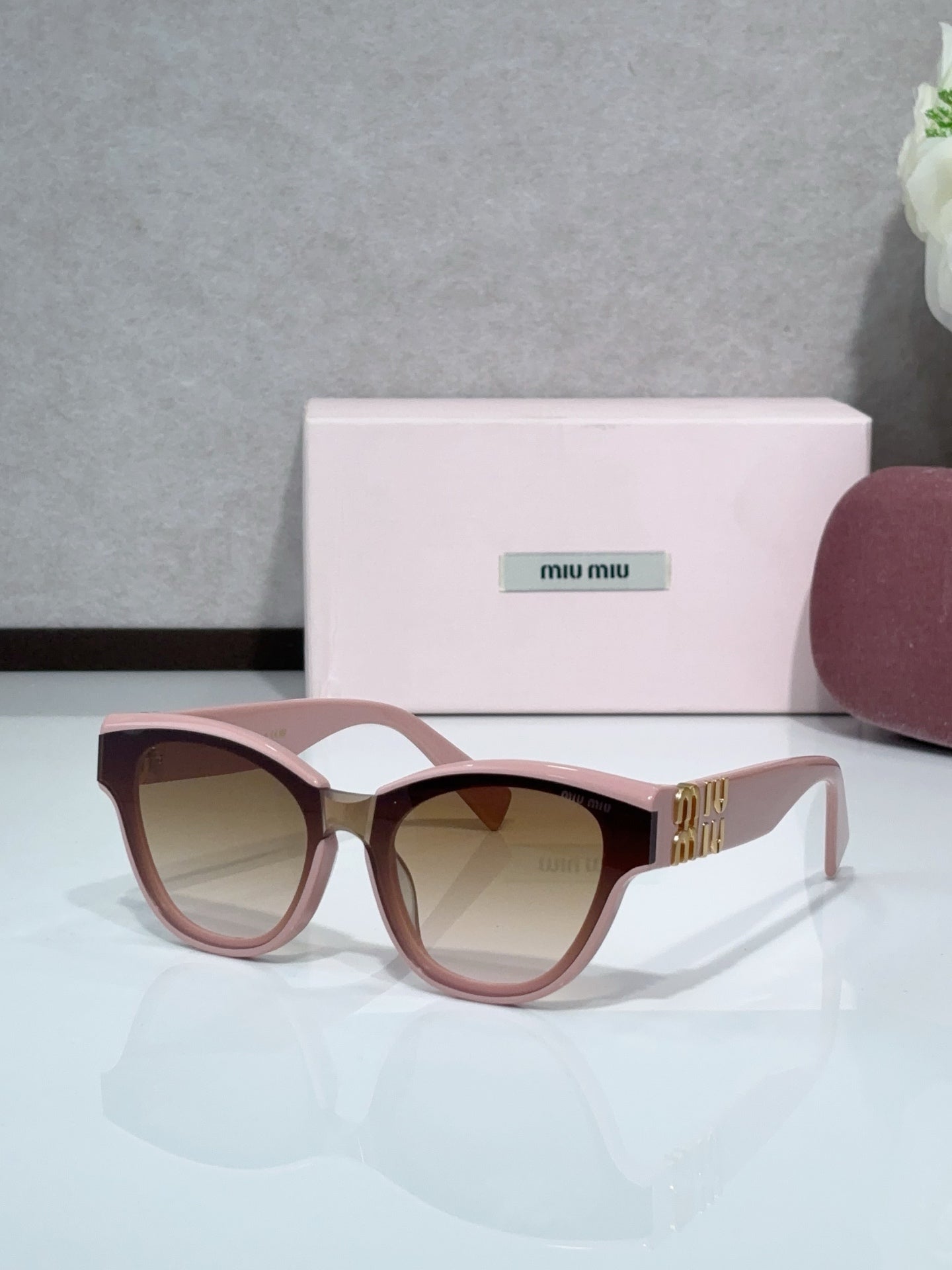 MiuMiu cat-eye sunglasses, pink frames with brown tinted lenses