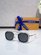 Louis Vuitton round sunglasses with silver-tone frame and dark lenses, side view.