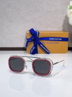 Louis Vuitton round sunglasses with pink-trim frame and dark lenses, open temples.