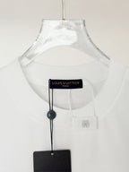 White Louis Vuitton T-shirt showing inner neck label and hanging tag