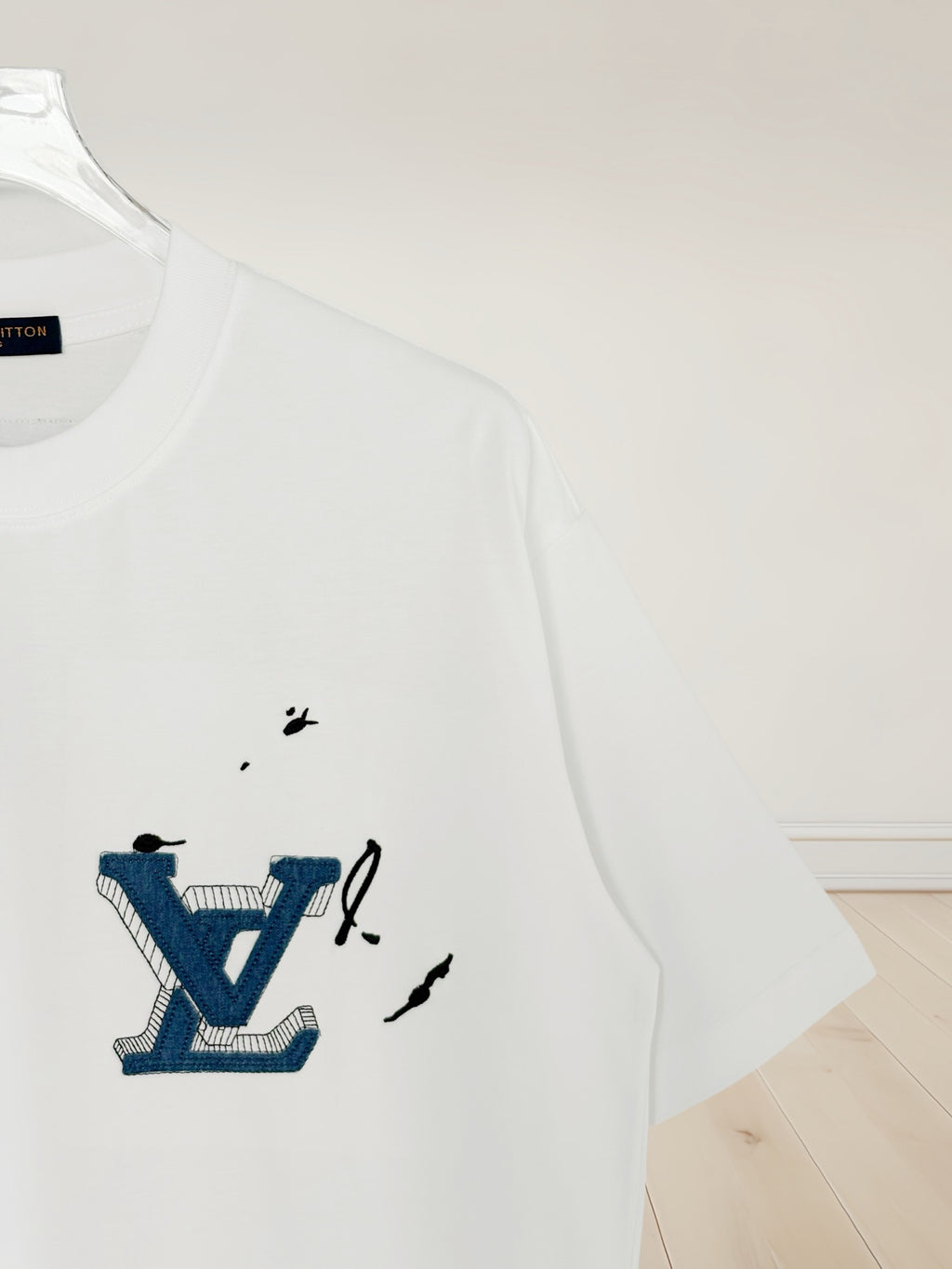 White Louis Vuitton T-shirt with blue LV graphic on the chest
