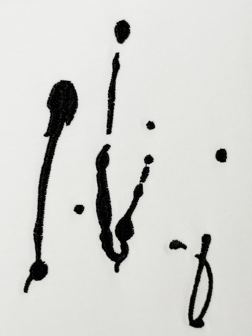 White Louis Vuitton T-shirt close-up of black scribble-style artwork print