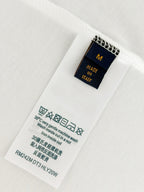White Louis Vuitton T-shirt care label showing Made in Italy details