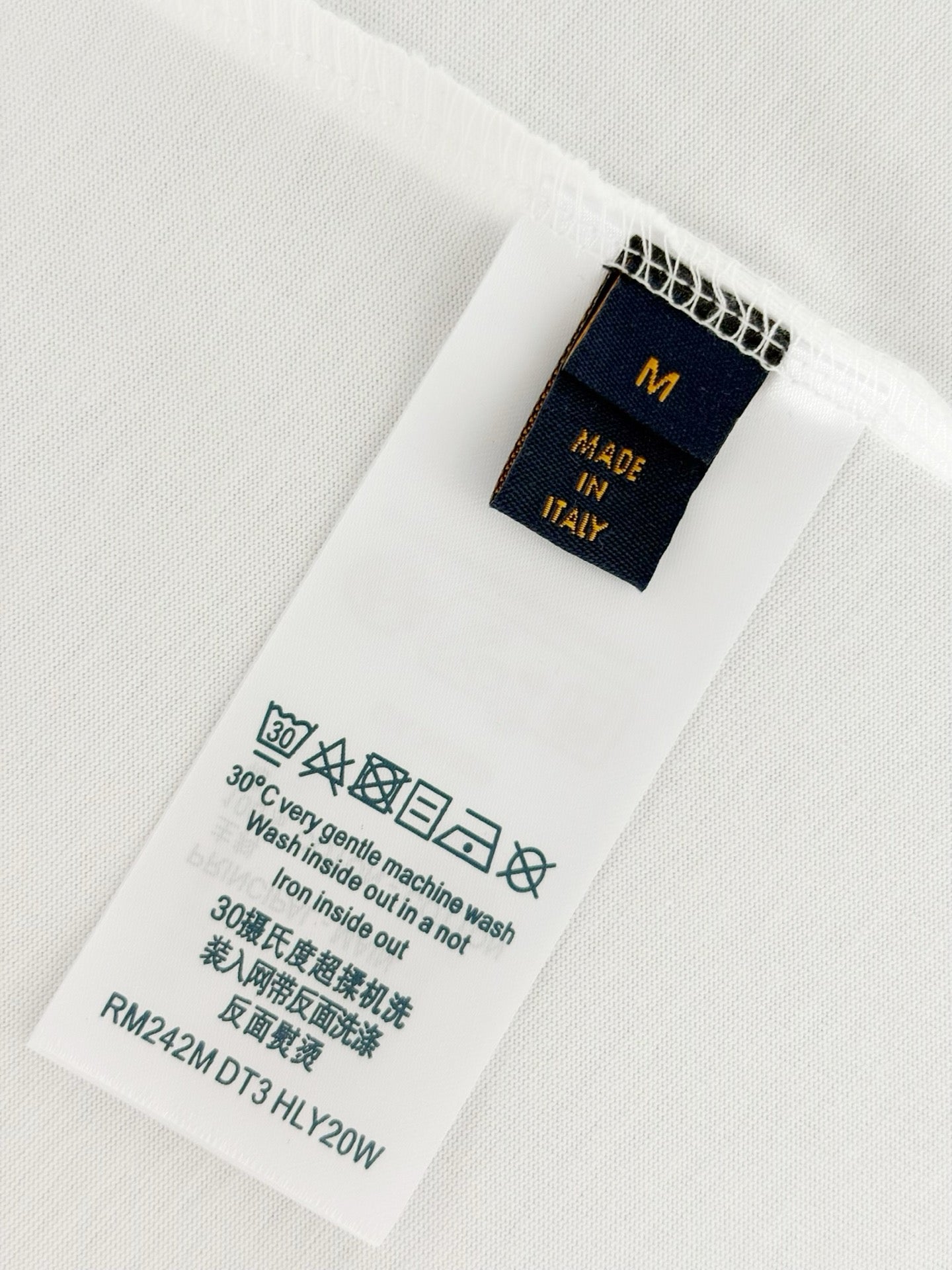 White Louis Vuitton T-shirt care label showing Made in Italy details