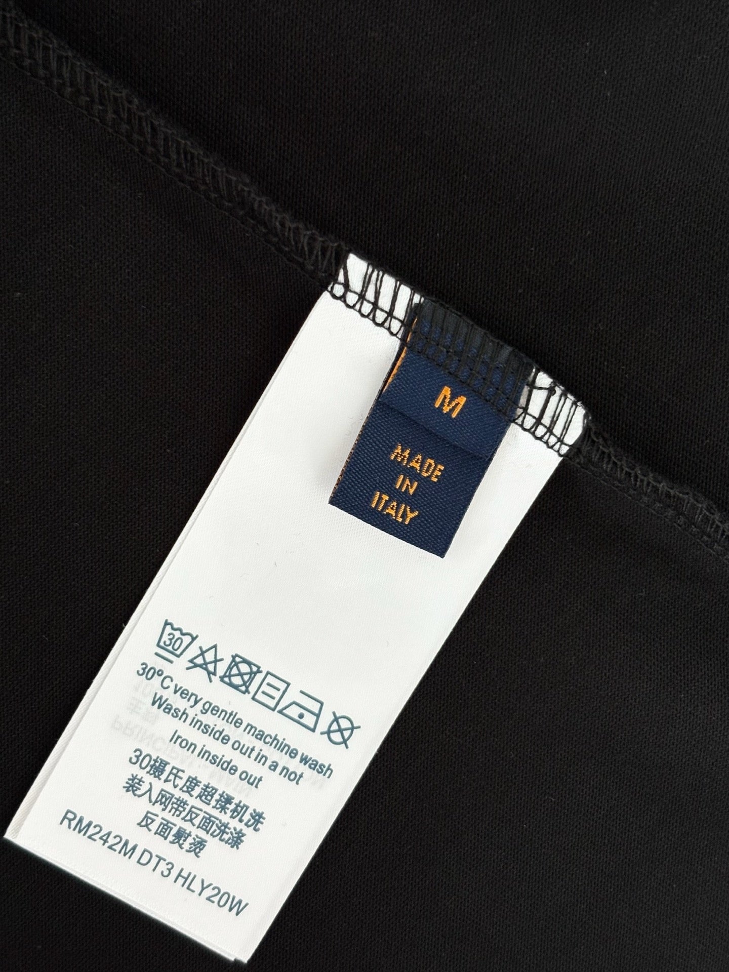 T-shirt care label and size tag on seam with Made in Italy text