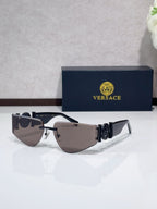 Shield sunglasses with dark frame accents, gold-tone details, and dark tinted lenses