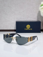Shield sunglasses with gold-tone metal frame and dark tinted lenses