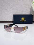 Shield sunglasses with gold-tone metal frame and light pink tinted lenses