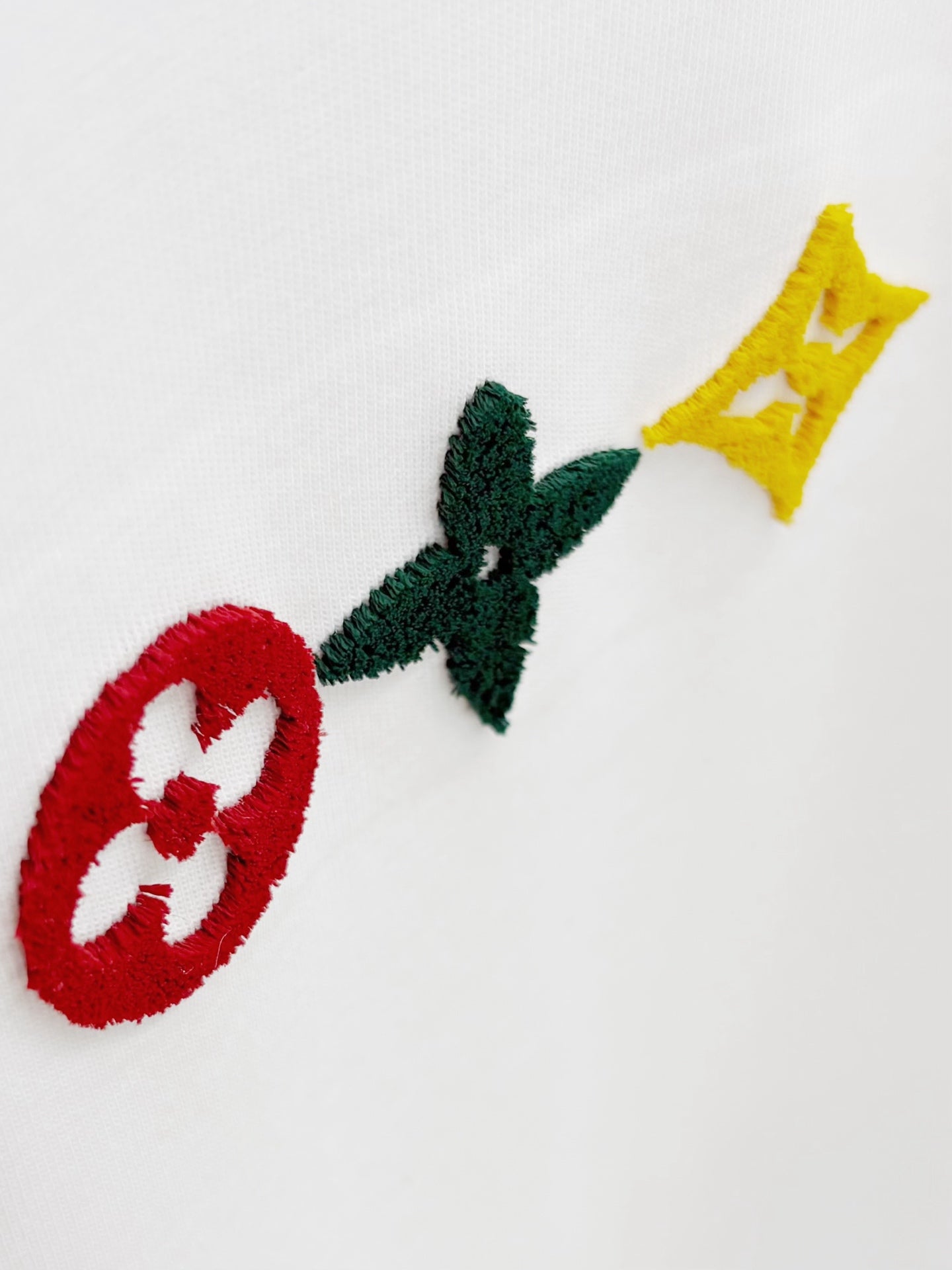 Louis Vuitton white T-shirt with embroidered red, green, and yellow motifs