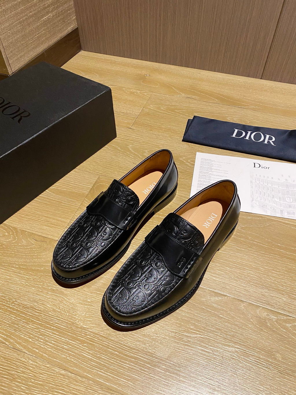 Black leather embossed loafers with strap detail and cushioned insole