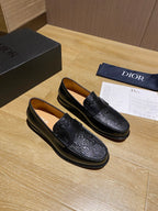 Black leather loafers with embossed pattern and strap detail, low profile sole