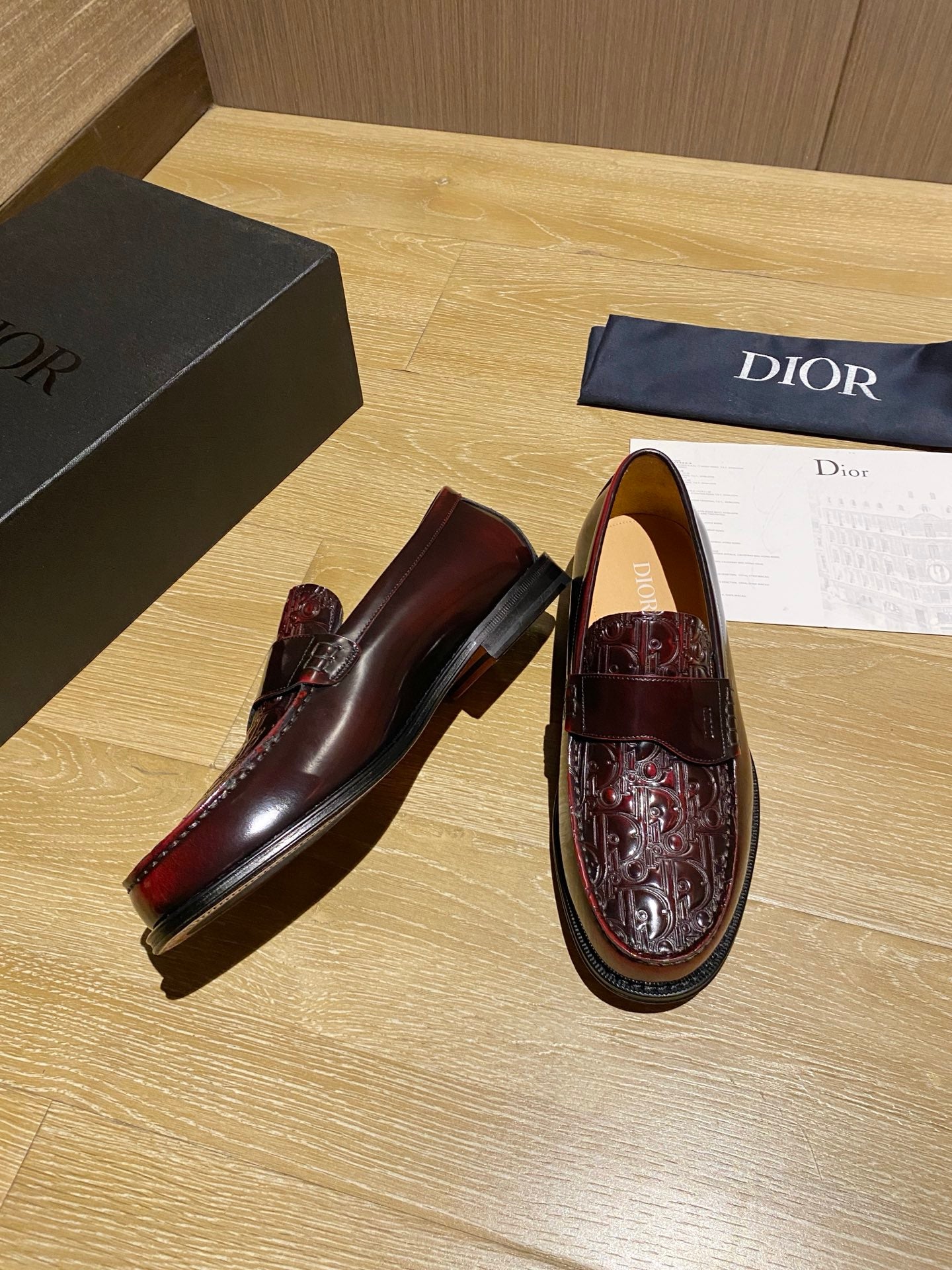 Pair of burgundy leather loafers with embossed uppers and rounded toe