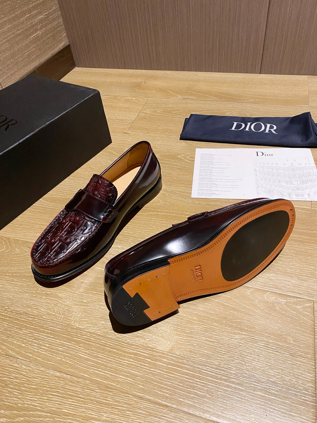 Burgundy leather loafers with tan interior and decorative heel detail